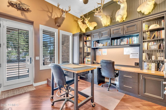 2371 E Sanoque Ct, Gilbert, AZ 85298 - home office with built in study area, light wood-style flooring, and a towering ceiling