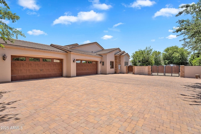 2371 E Sanoque Ct, Gilbert, AZ 85298 - view of front facade with a gate, a garage, decorative driveway, stucco siding, and a tiled roof