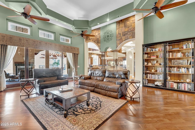 2371 E Sanoque Ct, Gilbert, AZ 85298 - living room with ceiling fan, arched walkways, a towering ceiling, wood finished floors, and recessed lighting