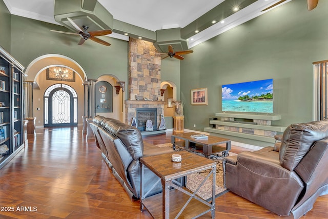 2371 E Sanoque Ct, Gilbert, AZ 85298 - living area with arched walkways, ceiling fan, a high ceiling, a stone fireplace, and recessed lighting