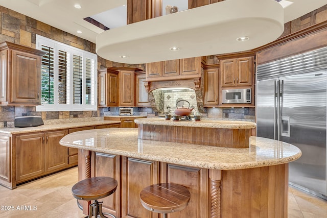 2371 E Sanoque Ct, Gilbert, AZ 85298 - kitchen with built in appliances, a center island, backsplash, light tile patterned floors, and recessed lighting