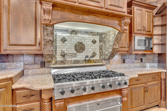 2371 E Sanoque Ct, Gilbert, AZ 85298 - kitchen featuring appliances with stainless steel finishes, decorative backsplash, light stone countertops, a warming drawer, and brown cabinetry