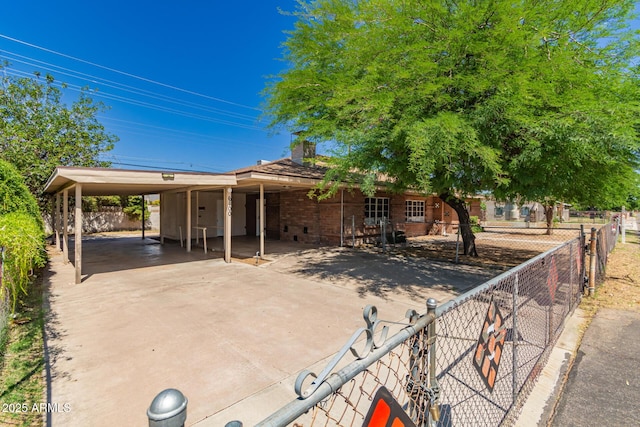 6100 N 36th Ave, Phoenix, AZ 85019 - view of front of house featuring a chimney, a carport, driveway, and brick siding