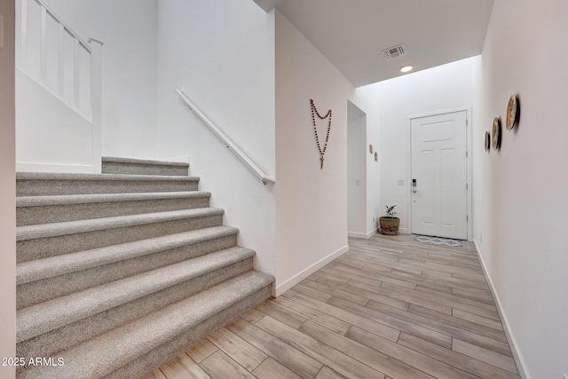 entrance foyer featuring stairway, wood finished floors, visible vents, baseboards, and recessed lighting