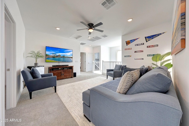 living room with recessed lighting, visible vents, and light colored carpet