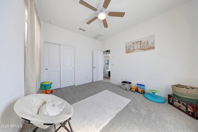 interior space featuring visible vents, ceiling fan, baseboards, and carpet