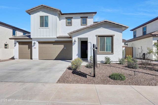 view of front facade featuring board and batten siding, concrete driveway, an attached garage, and a tiled roof