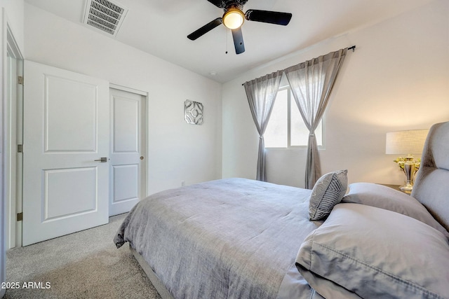 carpeted bedroom featuring visible vents and ceiling fan