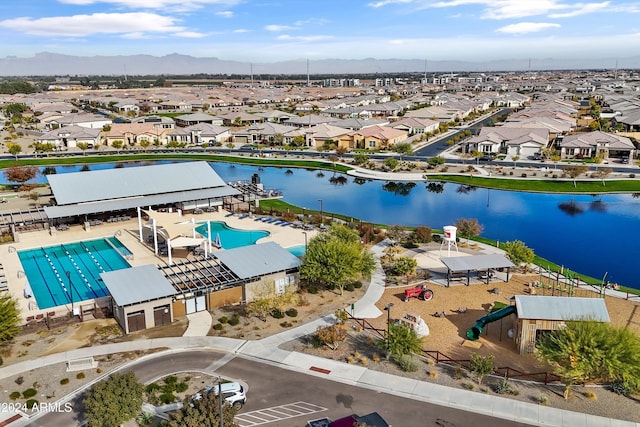 birds eye view of property with a water and mountain view