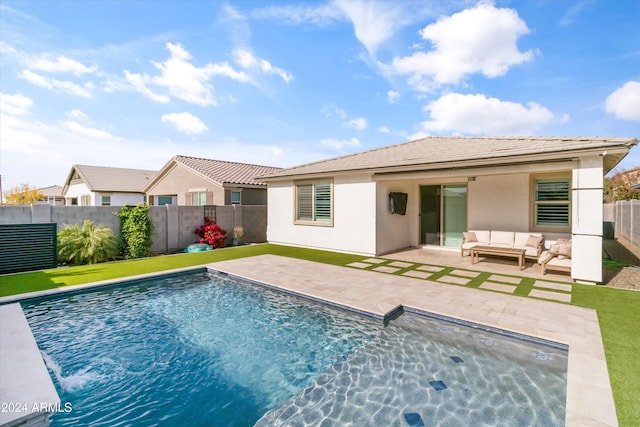 back of property with an outdoor living space, a fenced in pool, and a patio area