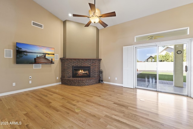 unfurnished living room featuring baseboards, visible vents, and light wood finished floors