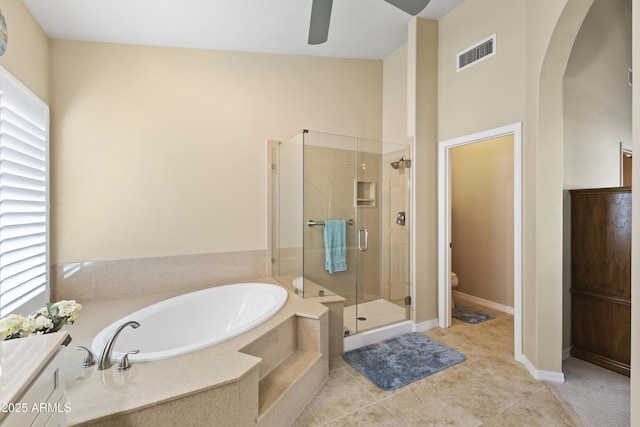 full bath with visible vents, toilet, a stall shower, a bath, and tile patterned floors