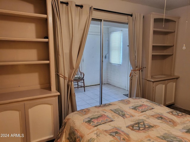 bedroom with a textured ceiling and light tile patterned floors