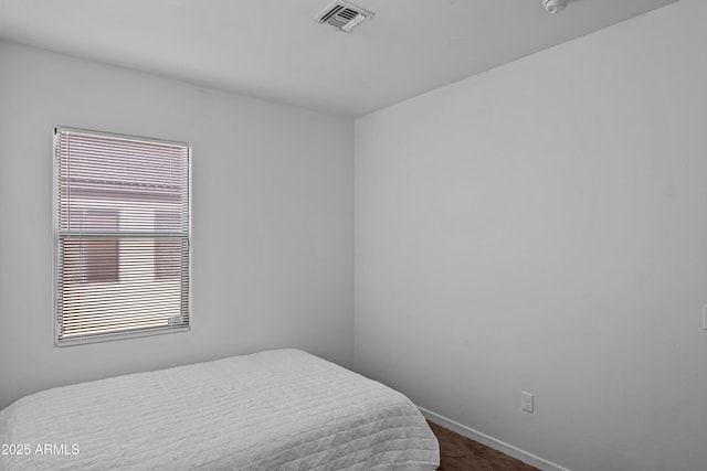 bedroom with dark colored carpet