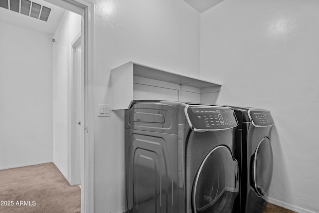 laundry room featuring washing machine and dryer and carpet