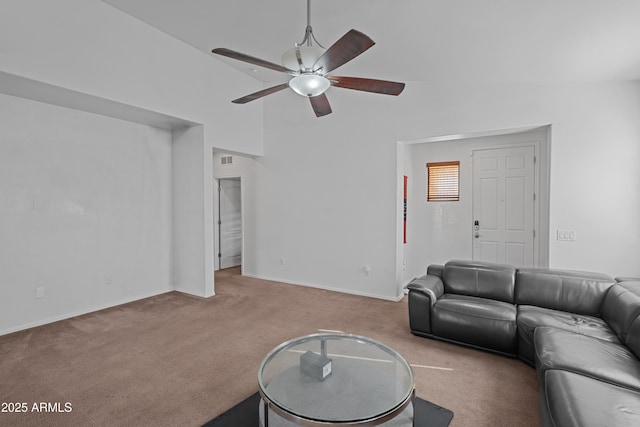 carpeted living room with ceiling fan and lofted ceiling