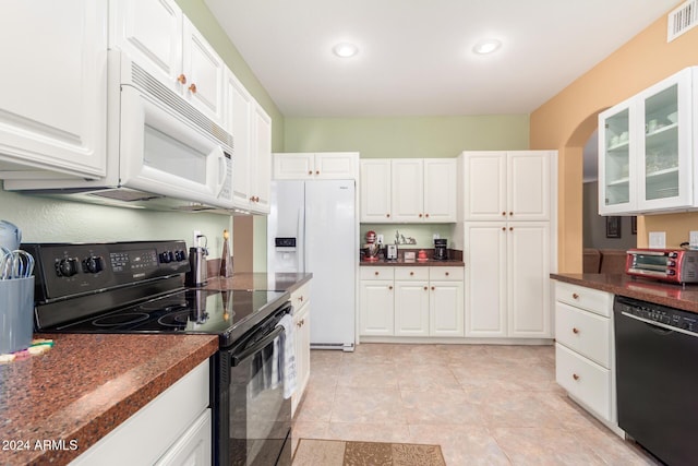 kitchen featuring light tile patterned flooring, black appliances, and white cabinetry