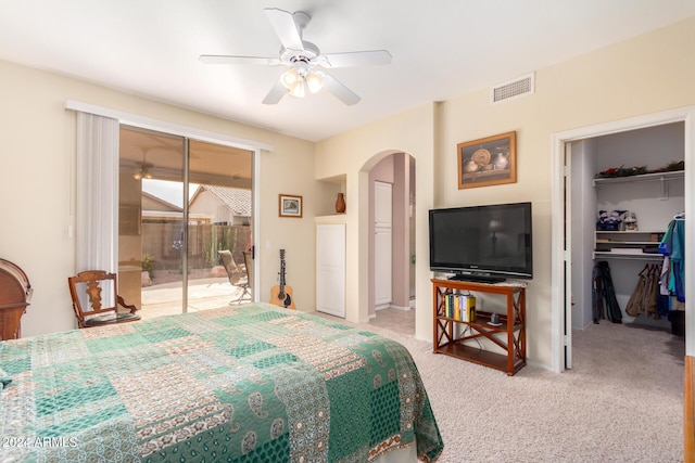 bedroom with a closet, ceiling fan, light colored carpet, and access to outside