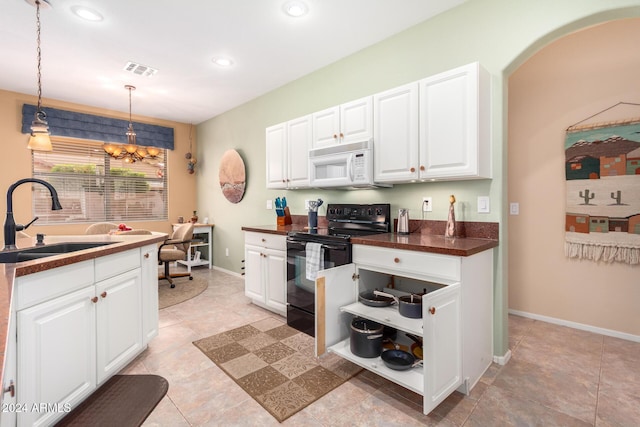 kitchen featuring black electric range oven, white cabinetry, hanging light fixtures, and sink