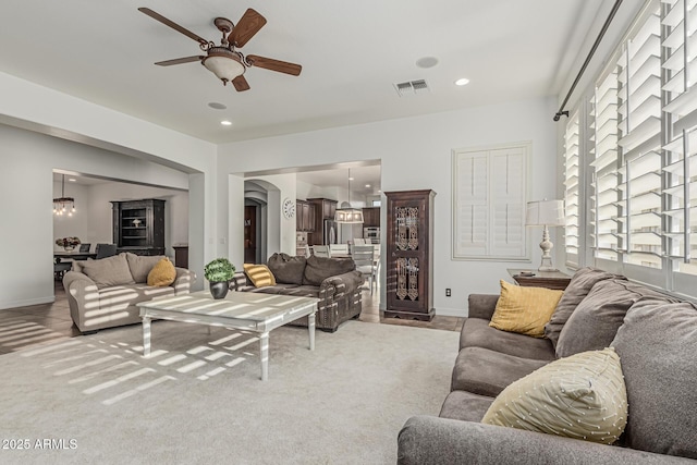 living area with ceiling fan, baseboards, light carpet, and recessed lighting