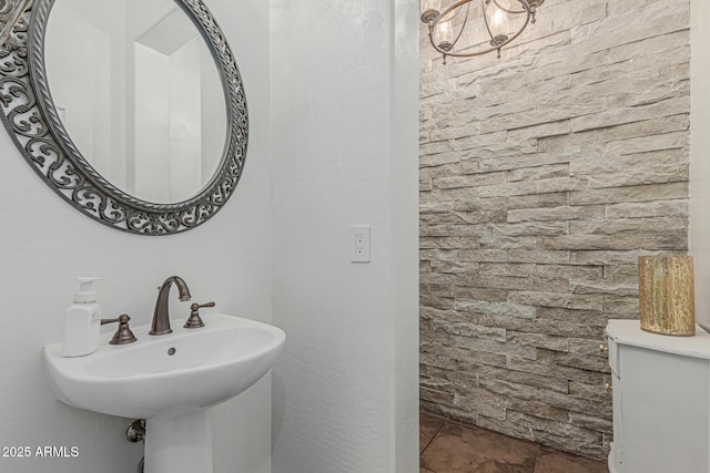 bathroom with a sink and a chandelier