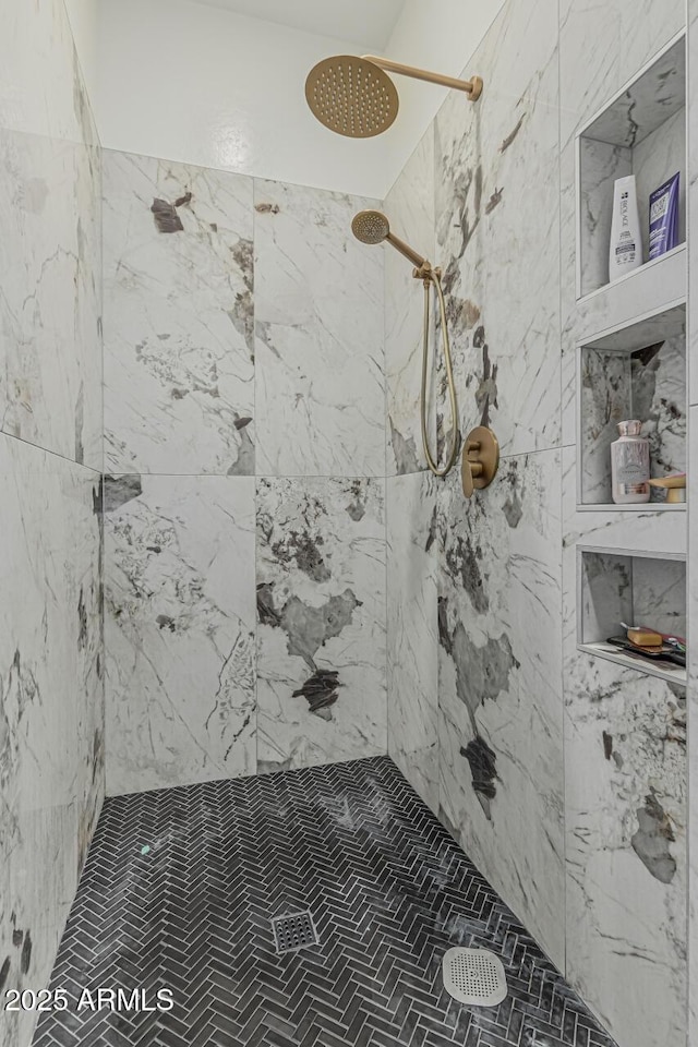 bathroom with a tile shower