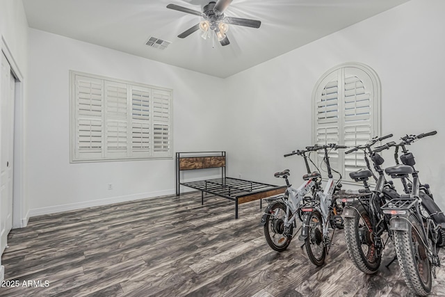 rec room featuring wood finished floors, a ceiling fan, and baseboards