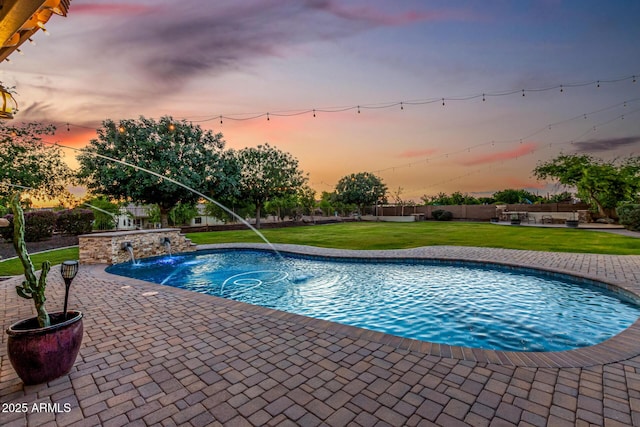 view of swimming pool featuring a patio and a yard