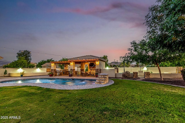 pool at dusk with a patio area