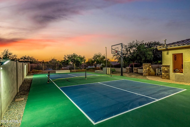 view of tennis court featuring fence