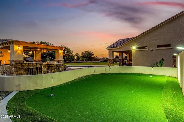 view of pool with an area to practice putting