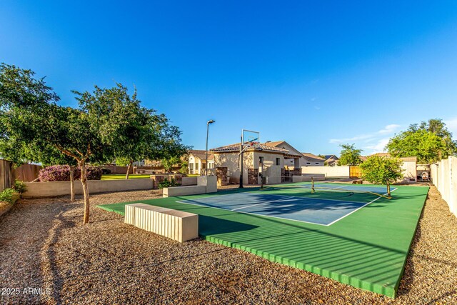 view of tennis court featuring fence