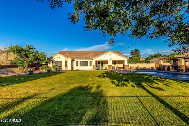 view of front of property with stucco siding, a patio area, and a tile roof