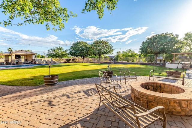 view of patio with a fire pit and a swimming pool