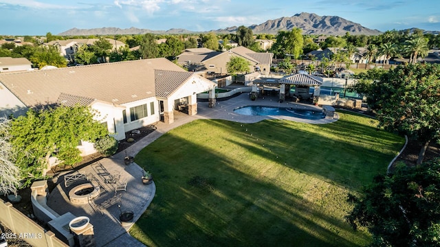 aerial view of residential area with mountains and a pool