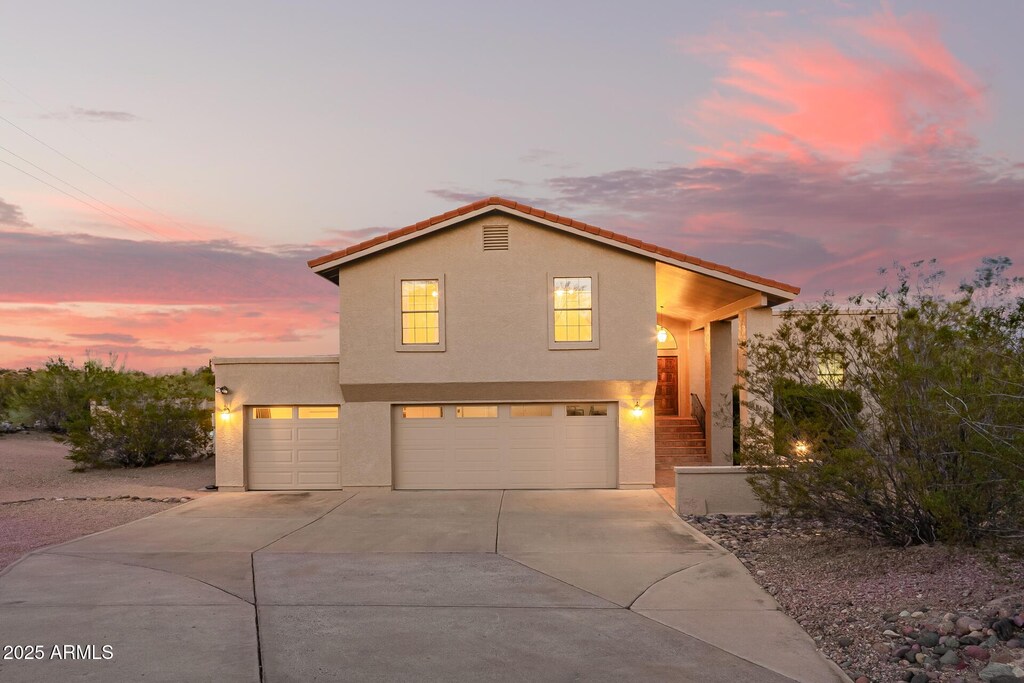15247 N Pelican Dr, Fountain Hills, AZ 85268 - view of front of house featuring stucco siding, driveway, and a garage