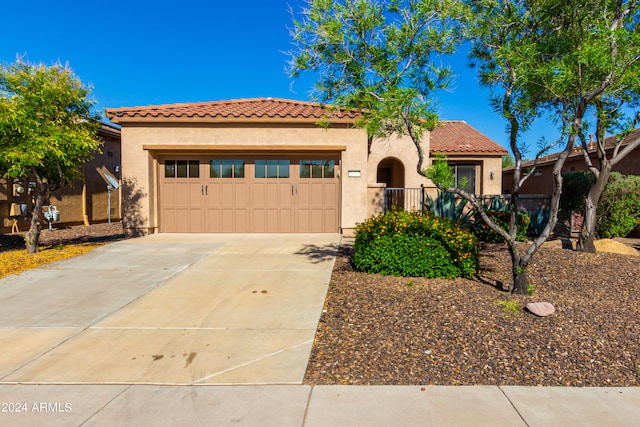 mediterranean / spanish-style house with a garage