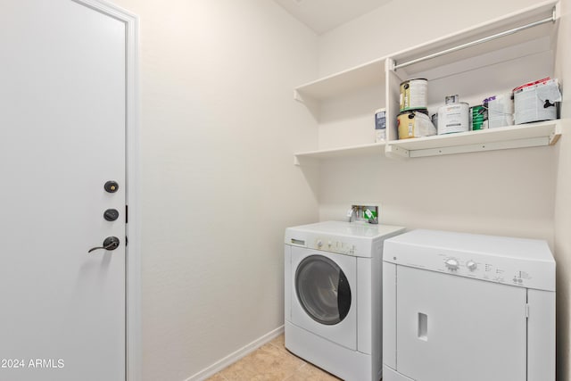 laundry area with washer hookup, light tile floors, and washer and dryer