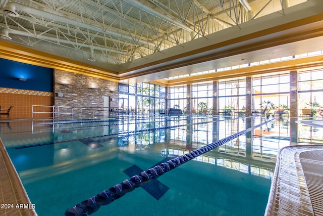 view of swimming pool with a hot tub