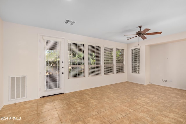 unfurnished room featuring ceiling fan and light tile floors