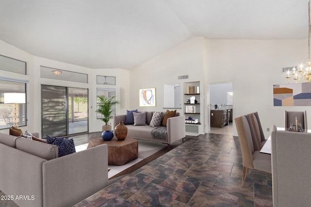 living room with high vaulted ceiling and a notable chandelier