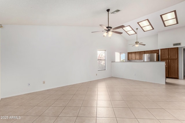 unfurnished living room featuring ceiling fan, light tile patterned floors, and high vaulted ceiling