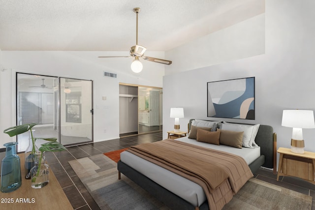 tiled bedroom featuring a textured ceiling, ceiling fan, and vaulted ceiling