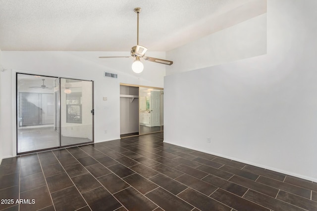 interior space featuring a textured ceiling, ceiling fan, and lofted ceiling