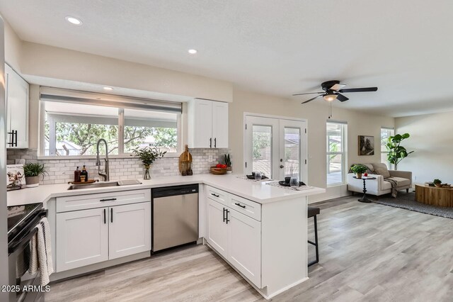 828 E Le Marche Ave, Phoenix, AZ 85022 - kitchen featuring dishwasher, a sink, black electric range, a peninsula, and open floor plan