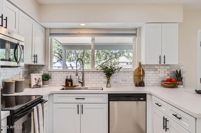 828 E Le Marche Ave, Phoenix, AZ 85022 - kitchen featuring appliances with stainless steel finishes, a sink, plenty of natural light, and backsplash