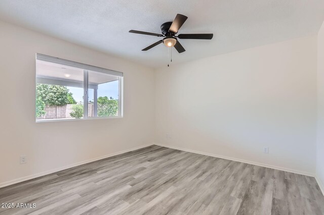 828 E Le Marche Ave, Phoenix, AZ 85022 - unfurnished room featuring wood finished floors, baseboards, and ceiling fan