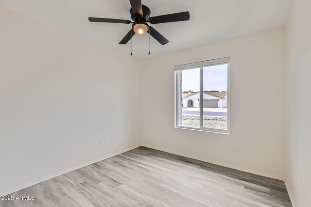 828 E Le Marche Ave, Phoenix, AZ 85022 - empty room featuring wood finished floors, ceiling fan, and baseboards