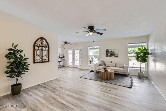 828 E Le Marche Ave, Phoenix, AZ 85022 - living room with french doors, light wood-style flooring, ceiling fan, and baseboards