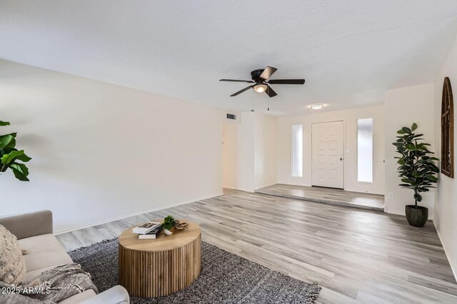 828 E Le Marche Ave, Phoenix, AZ 85022 - living area featuring wood finished floors, ceiling fan, and baseboards